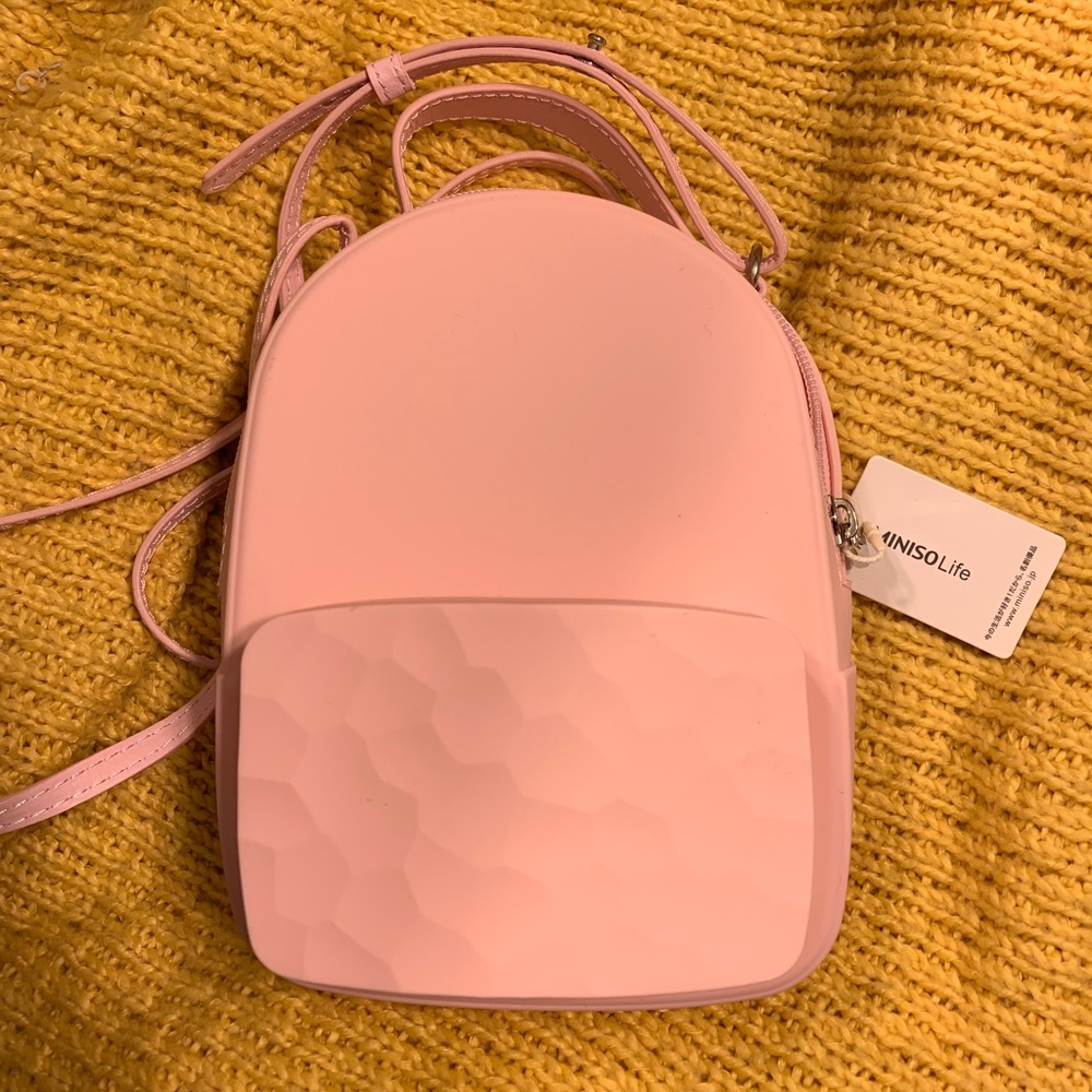 Silicon cross body mini purse.